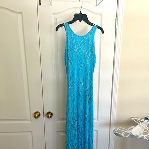 Cache evening dress with small opening in the back.